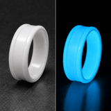 A split-view product photo of a glow powder ceramic ring band shown in two color states: matte white on the left against a dark gray surface, and bright glowing blue on the right against a black background. No person, animal, or real environment is present.